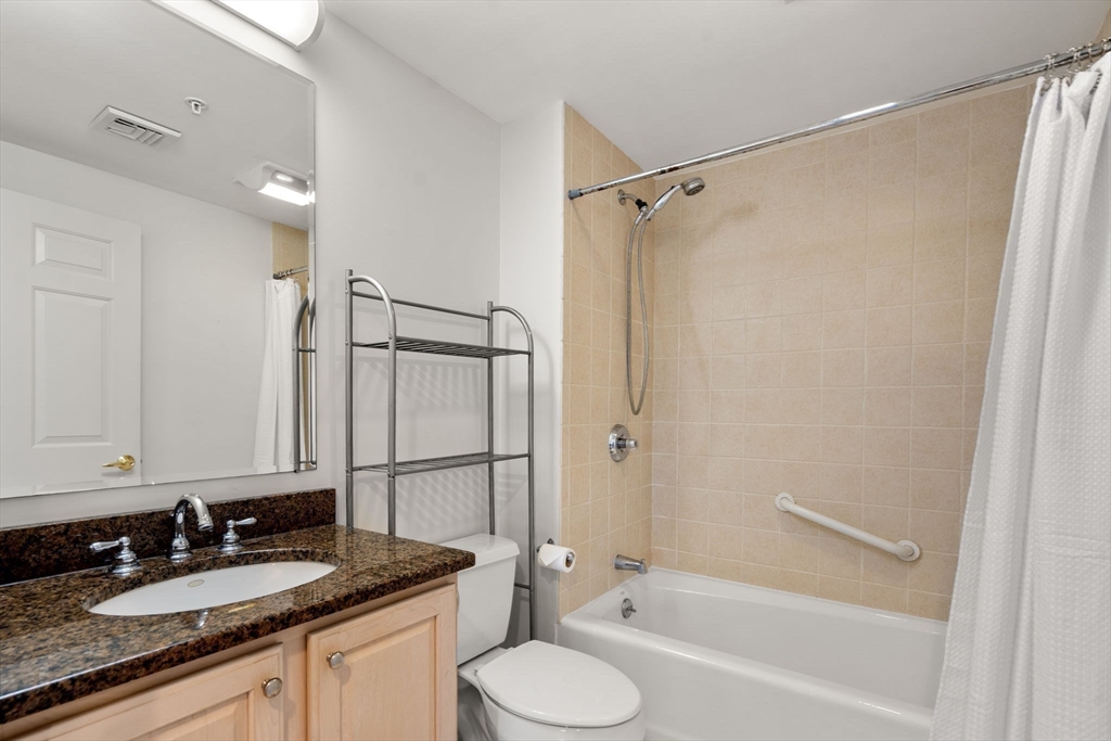 121 Centre Street, Unit PH3 Brookline, MA 02446 - Photo 26 of 32 a bathroom with a granite countertop sink toilet and shower
