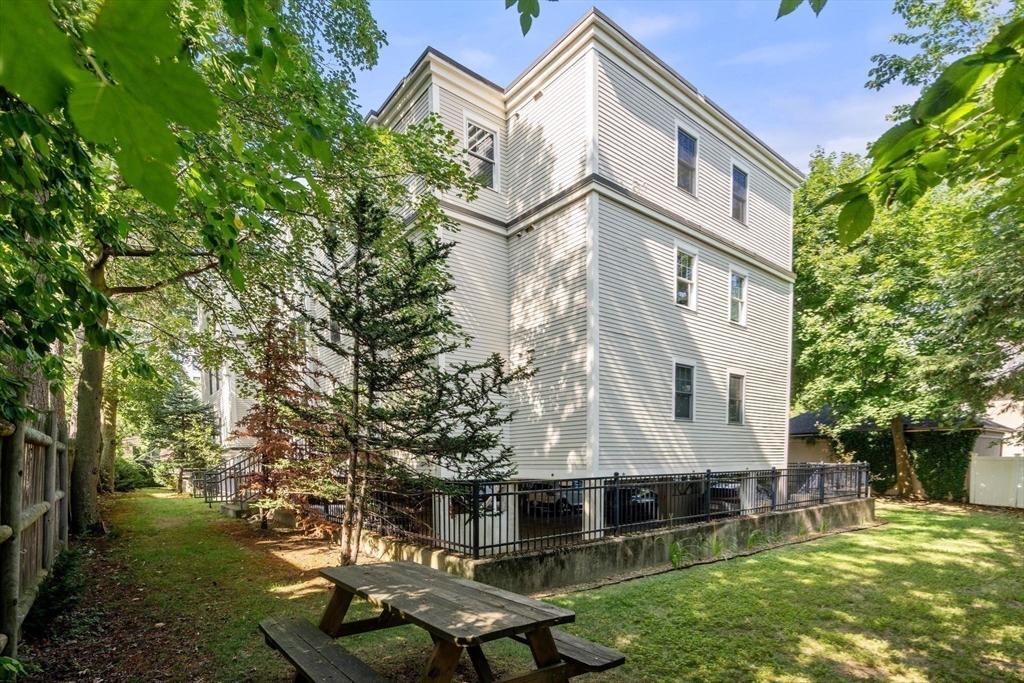 121 Centre Street, Unit PH3 Brookline, MA 02446 - Photo 29 of 32 front view of house with a yard