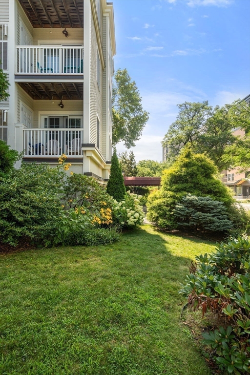 121 Centre Street, Unit PH3 Brookline, MA 02446 - Photo 31 of 32 a view of a house with a yard
