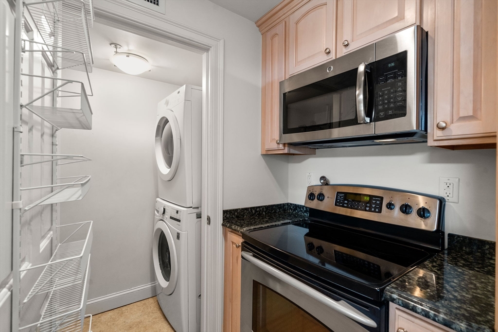 121 Centre Street, Unit PH3 Brookline, MA 02446 - Photo 5 of 32 a kitchen with a stove and a microwave