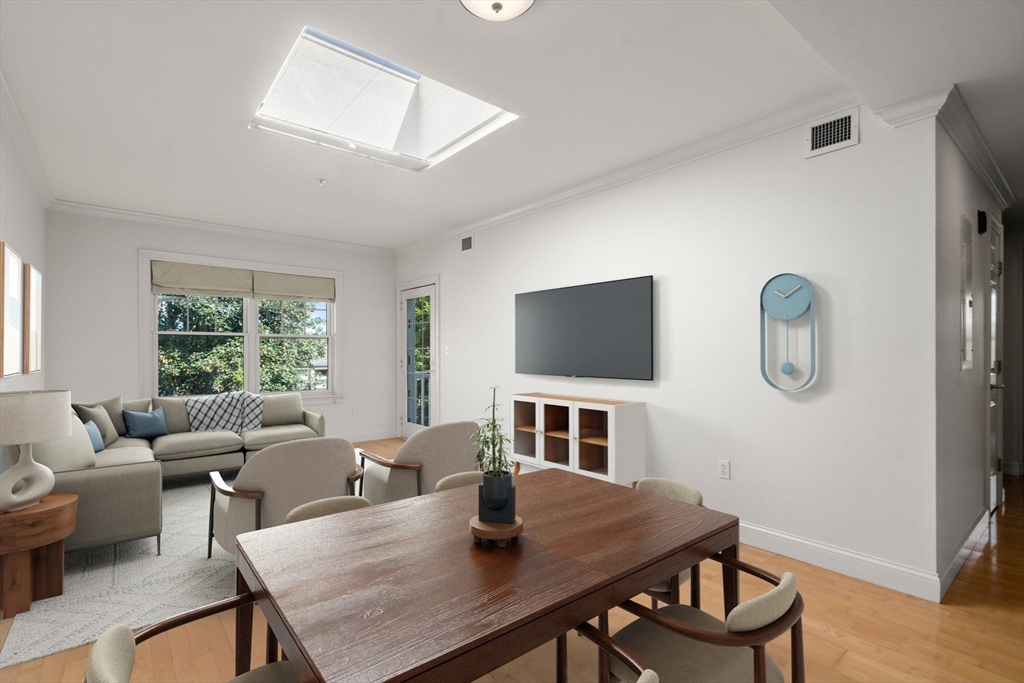 121 Centre Street, Unit PH3 Brookline, MA 02446 - Photo 8 of 32 a view of a dining room with furniture and a window