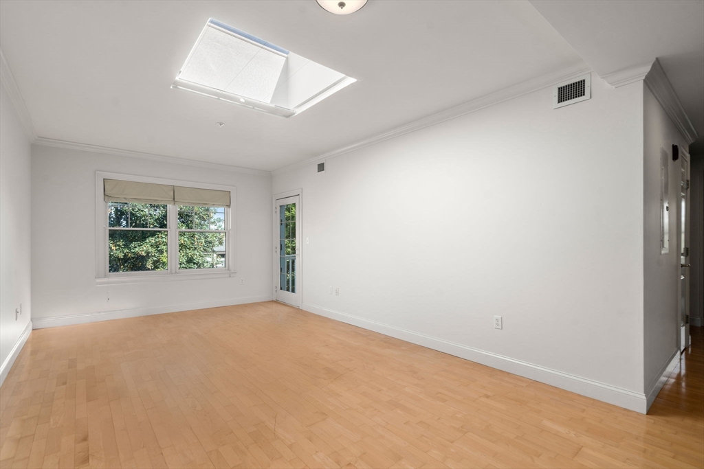 121 Centre Street, Unit PH3 Brookline, MA 02446 - Photo 9 of 32 an empty room with windows