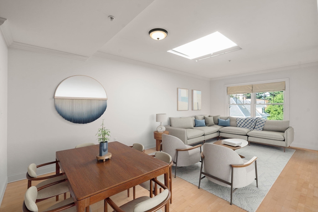 121 Centre Street, Unit PH3 Brookline, MA 02446 - Photo 10 of 32 a living room with furniture a window and a lamp