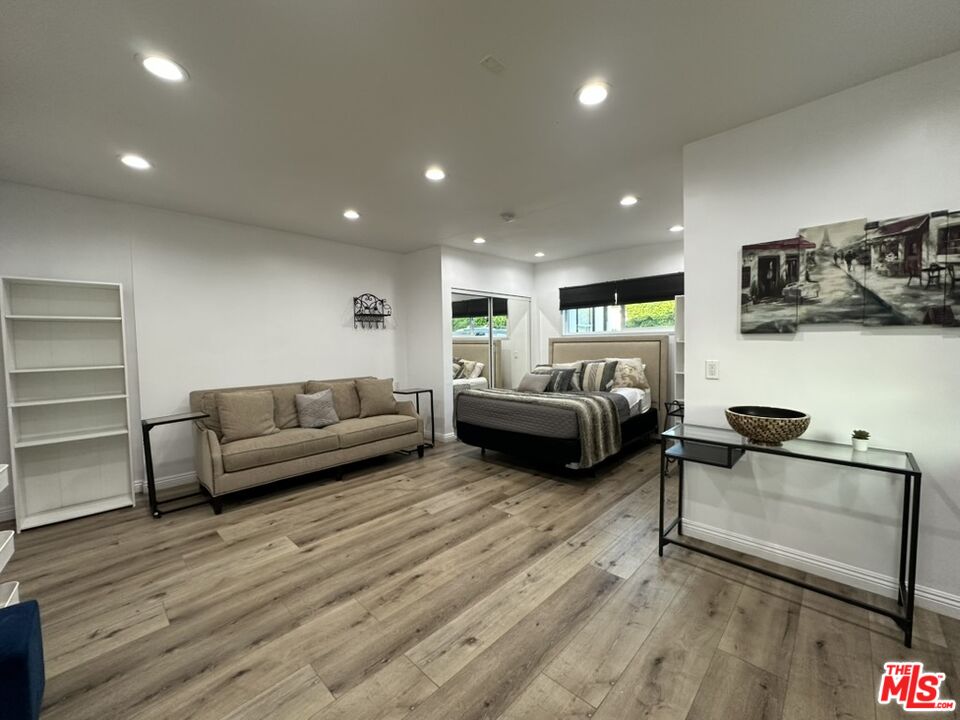 19542 Hart Street Reseda, CA 91335 - Photo 5 of 6 a living room with furniture and a wooden floor