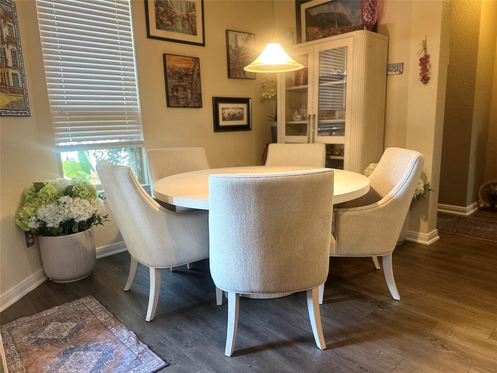 10420 Langham Drive Waco, TX 76708 - Photo 13 of 36 a view of a dining room with furniture and wooden floor