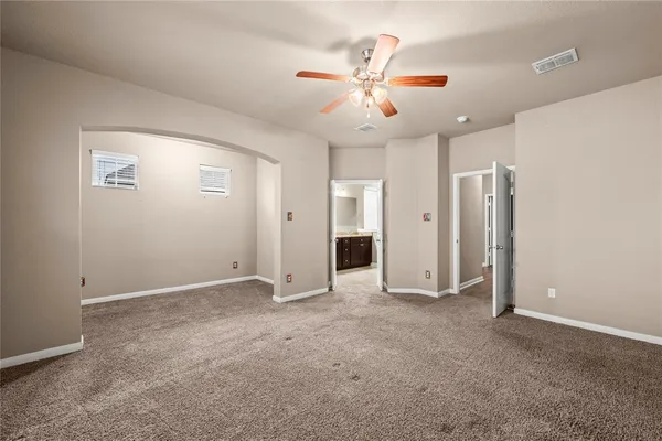 a view of an empty room with a ceiling fan
