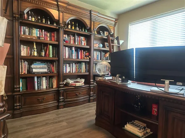 a room with bookshelf and a window
