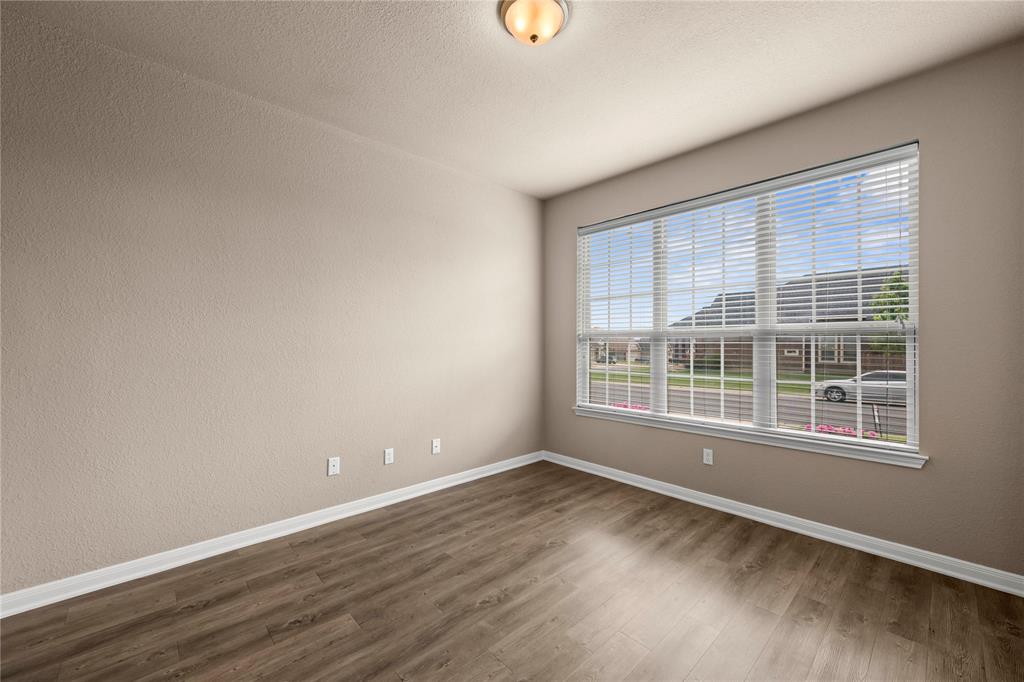 10420 Langham Drive Waco, TX 76708 - Photo 26 of 36 an empty room with wooden floor and windows