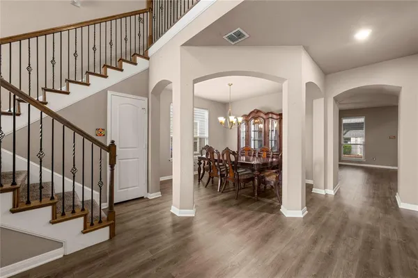 a view of entryway with dining room and wooden floor