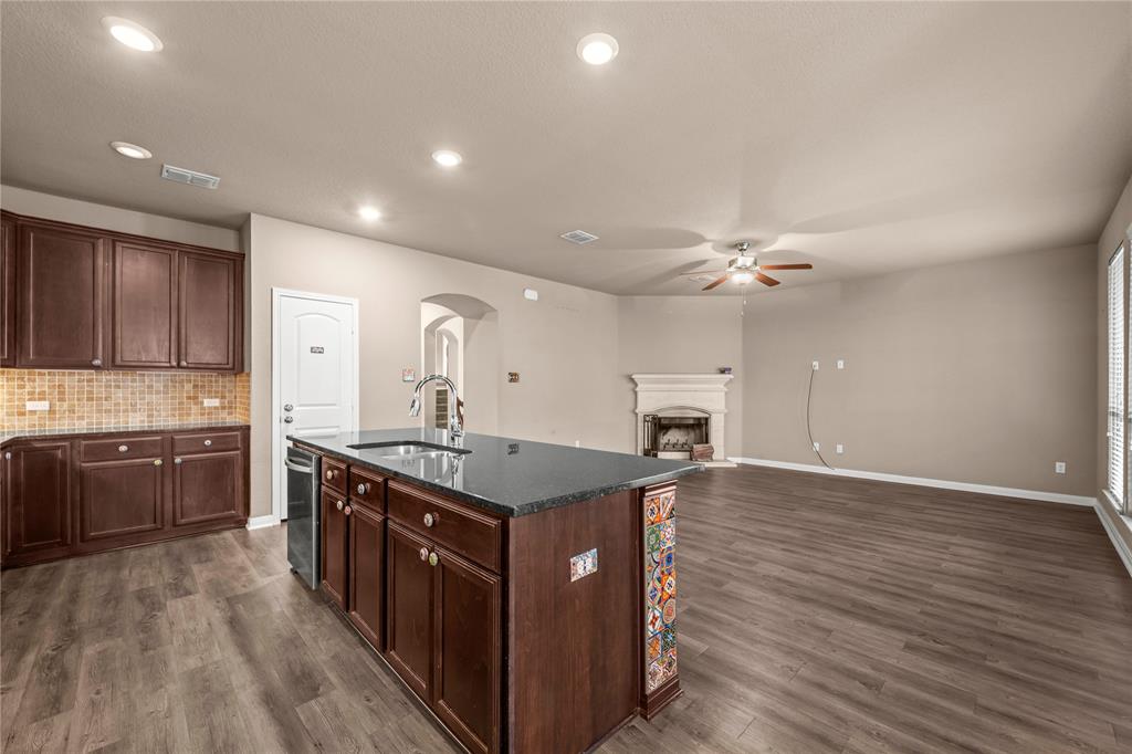 10420 Langham Drive Waco, TX 76708 - Photo 6 of 36 a kitchen with stainless steel appliances granite countertop a stove a sink dishwasher and a refrigerator with wooden floor