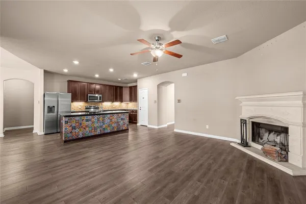 a room with kitchen view and a fireplace