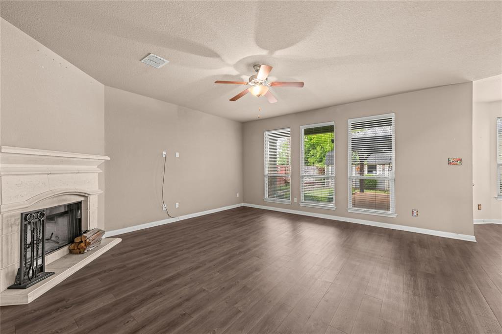 10420 Langham Drive Waco, TX 76708 - Photo 10 of 36 an empty room with wooden floor fan and windows