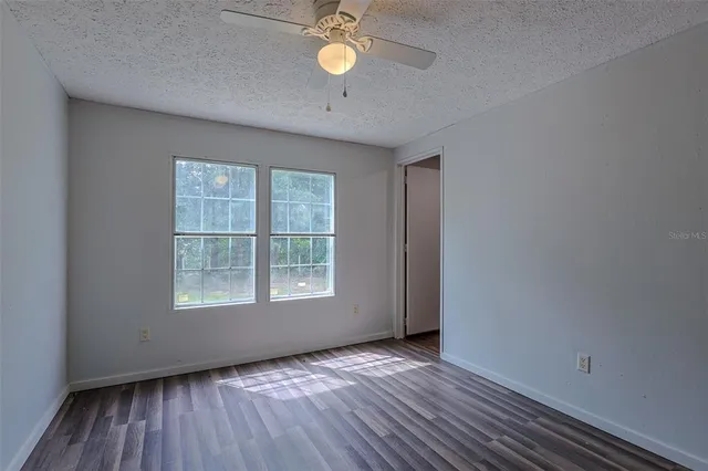 a bathroom with a granite countertop bathtub shower and toilet