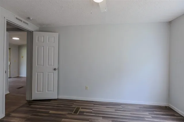 a view of a kitchen with a sink stove cabinets and empty room