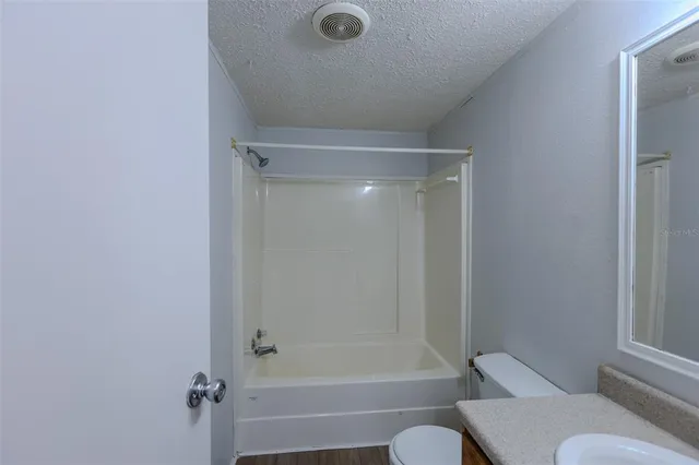 a view of a kitchen with a sink stove cabinets and empty room