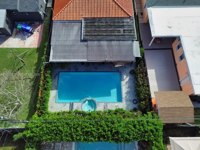 an aerial view of multiple houses with a yard