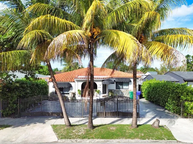 a view of a house with potted plants