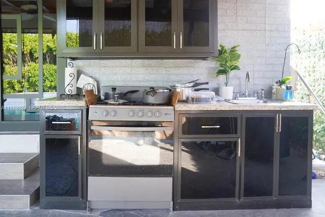 a kitchen with refrigerator and white stove