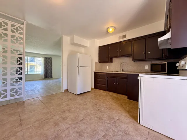 a kitchen with stainless steel appliances a sink and a refrigerator