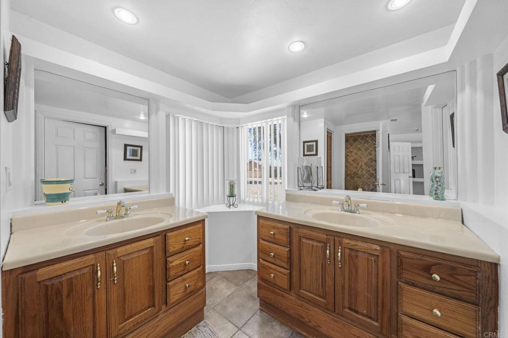 30265 Miller Road Valley Center, CA 92082 - Photo 27 of 56 a spacious bathroom with a granite countertop double vanity sink and mirror
