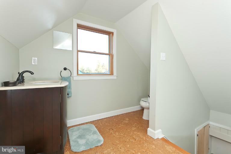 2420 Brambleton Road Baltimore, MD 21209 - Photo 22 of 30 a bathroom with a sink a toilet and a window