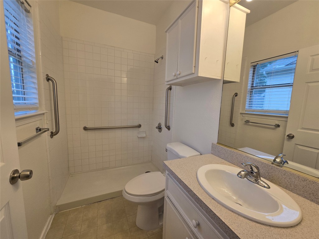 5404 Garden View Cove Austin, TX 78724 - Photo 14 of 28 a bathroom with a sink a toilet and shower