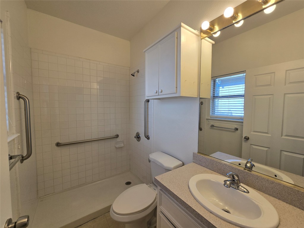 5404 Garden View Cove Austin, TX 78724 - Photo 15 of 28 a bathroom with a sink a toilet and shower