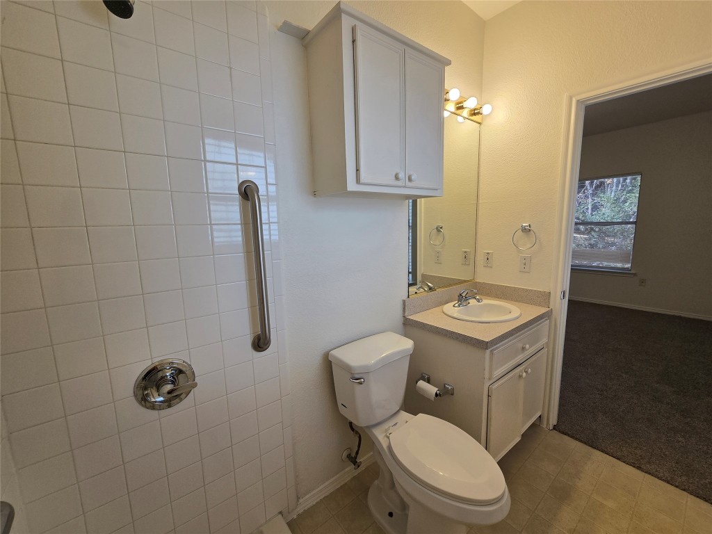 5404 Garden View Cove Austin, TX 78724 - Photo 17 of 28 a bathroom with a toilet a sink and shower