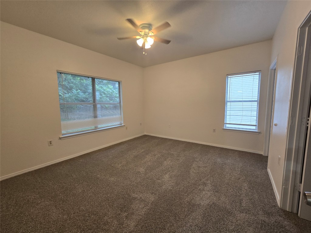 5404 Garden View Cove Austin, TX 78724 - Photo 20 of 28 an empty room with windows and fan