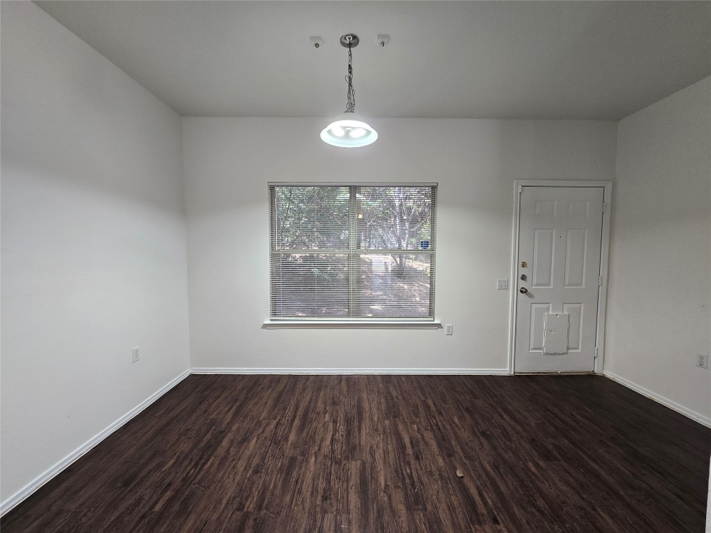 5404 Garden View Cove Austin, TX 78724 - Photo 5 of 28 a view of an empty room with wooden floor and a window