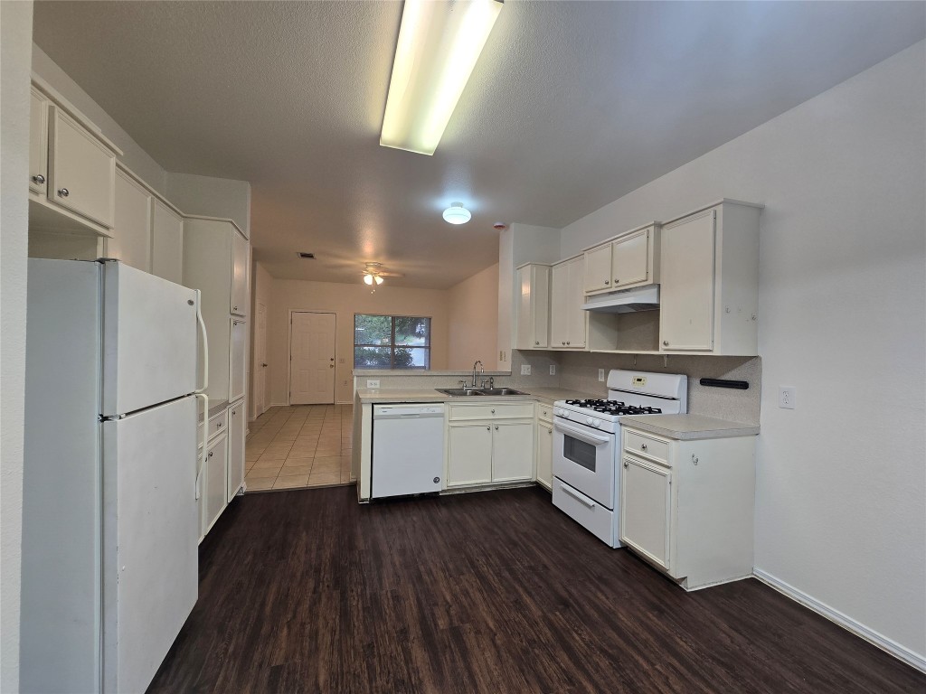 5404 Garden View Cove Austin, TX 78724 - Photo 6 of 28 a kitchen with white cabinets and white appliances