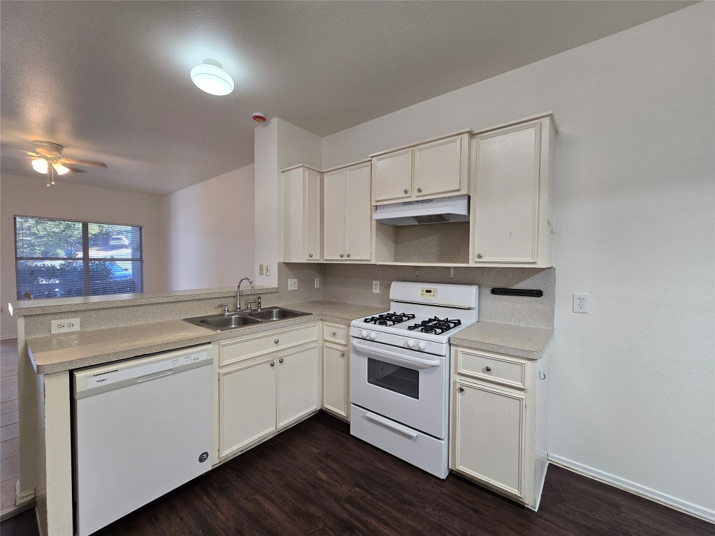 5404 Garden View Cove Austin, TX 78724 - Photo 10 of 28 a kitchen with a sink stove and cabinets