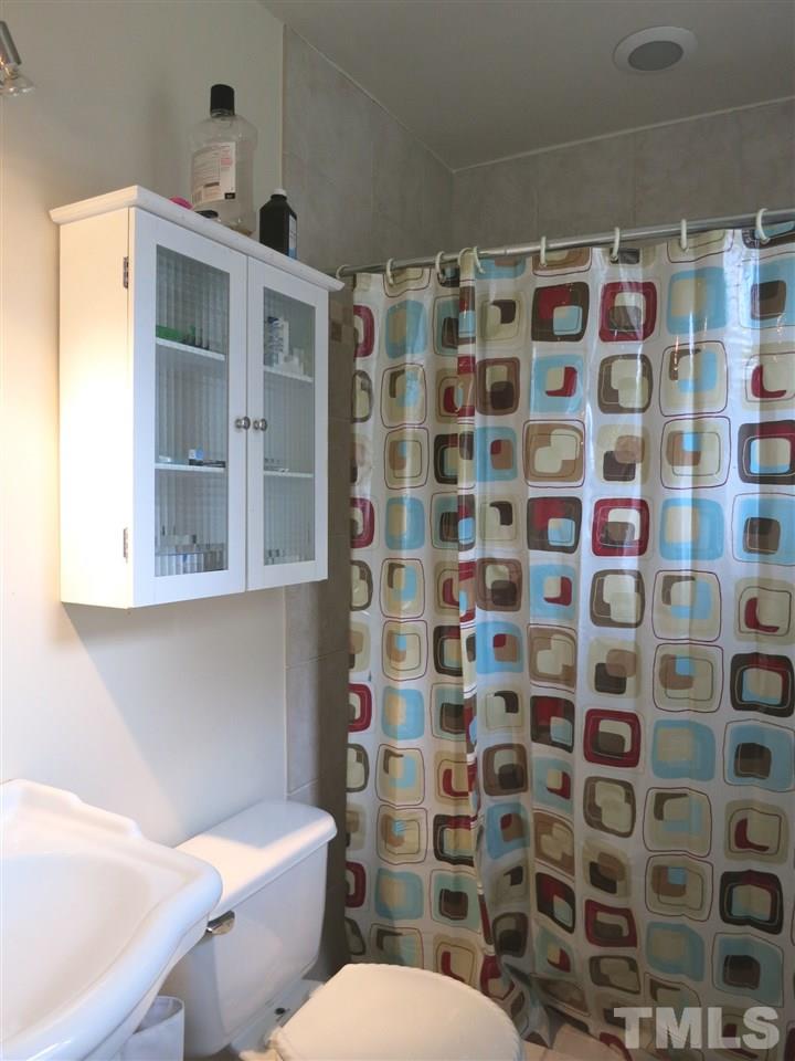 5305 Country Court Raleigh, NC 27609 - Photo 12 of 21 The spacious Master Bedroom offers a lg closet & updated private Bath w/pedestal sink, tiled flr & lg tiled shower.