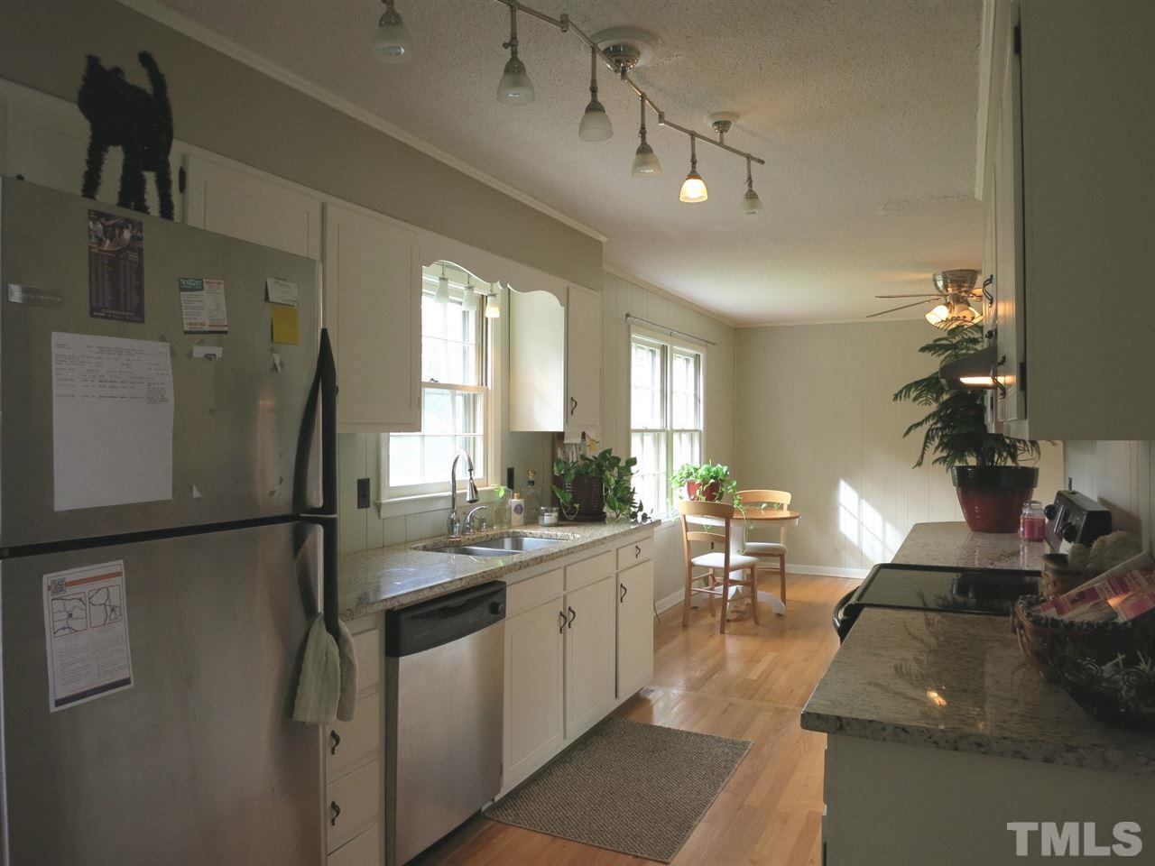 5305 Country Court Raleigh, NC 27609 - Photo 9 of 21 The updated Kitchen features granite counters, SS appliances, lots of white cabinets, track lighting, laundry area & doors to the backyard & to the Carport.