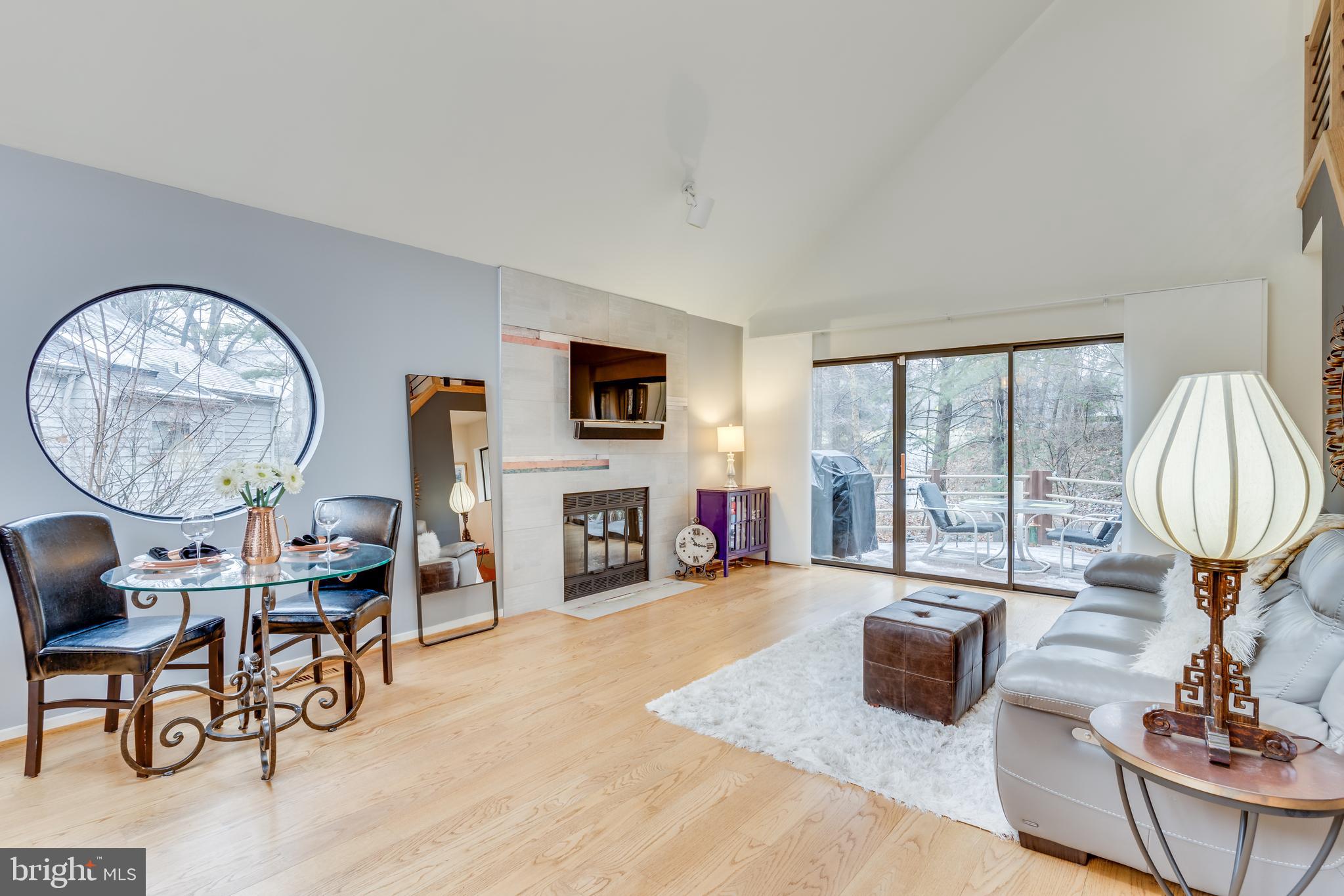 11900 Moss Point Lane Reston, VA 20194 - Photo 2 of 33 a living room with furniture a fireplace and a large window