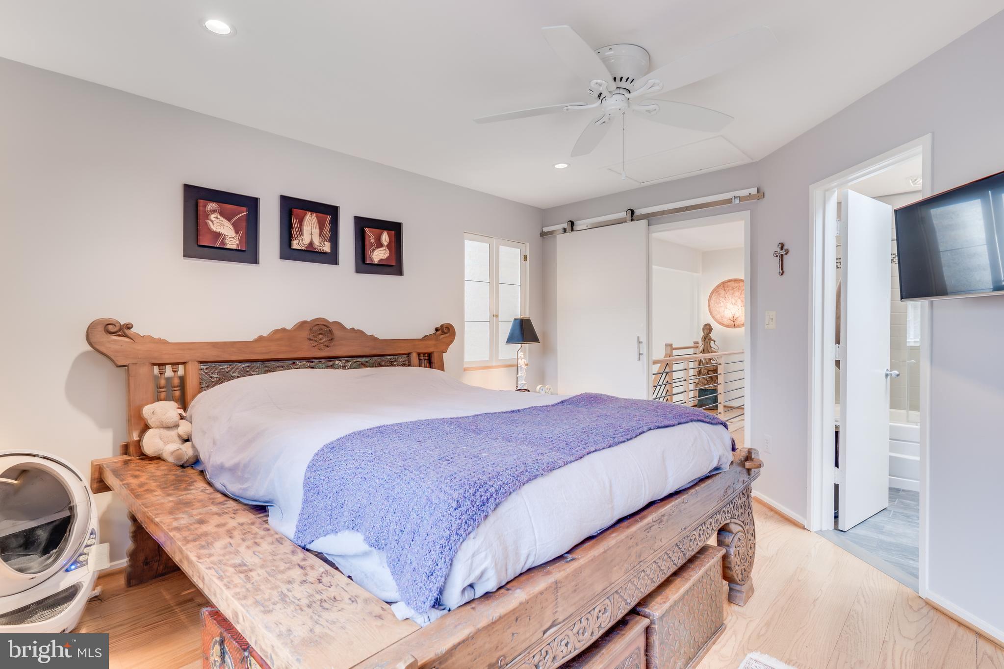 11900 Moss Point Lane Reston, VA 20194 - Photo 15 of 33 a bedroom with a bed and a chandelier