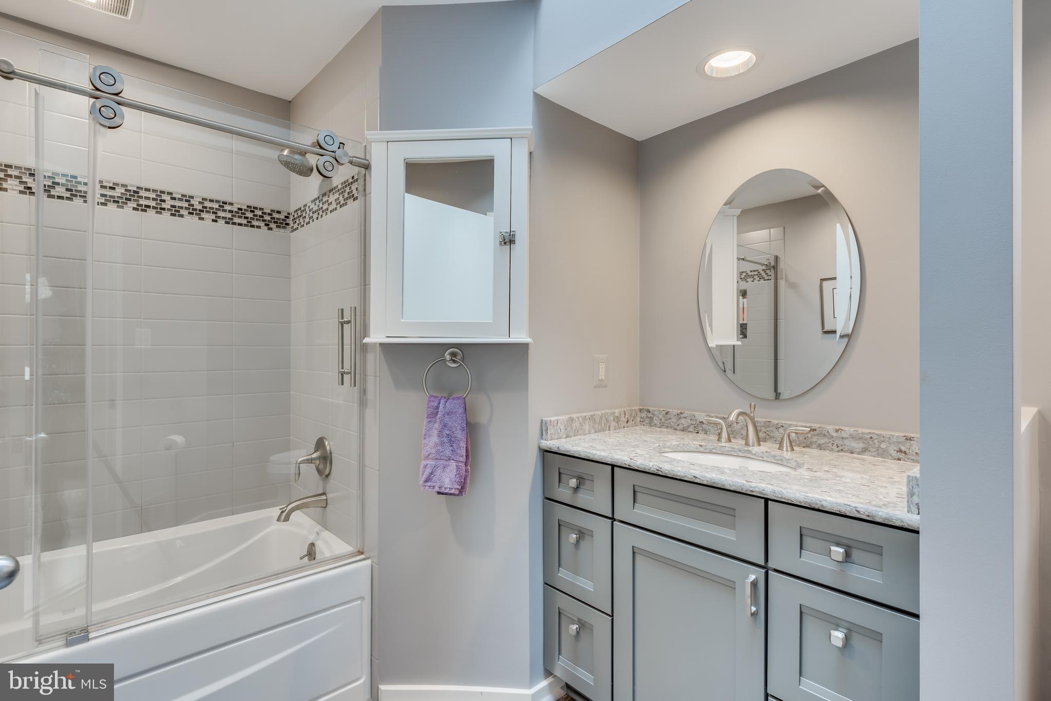 11900 Moss Point Lane Reston, VA 20194 - Photo 17 of 33 a bathroom with a tub sink and mirror