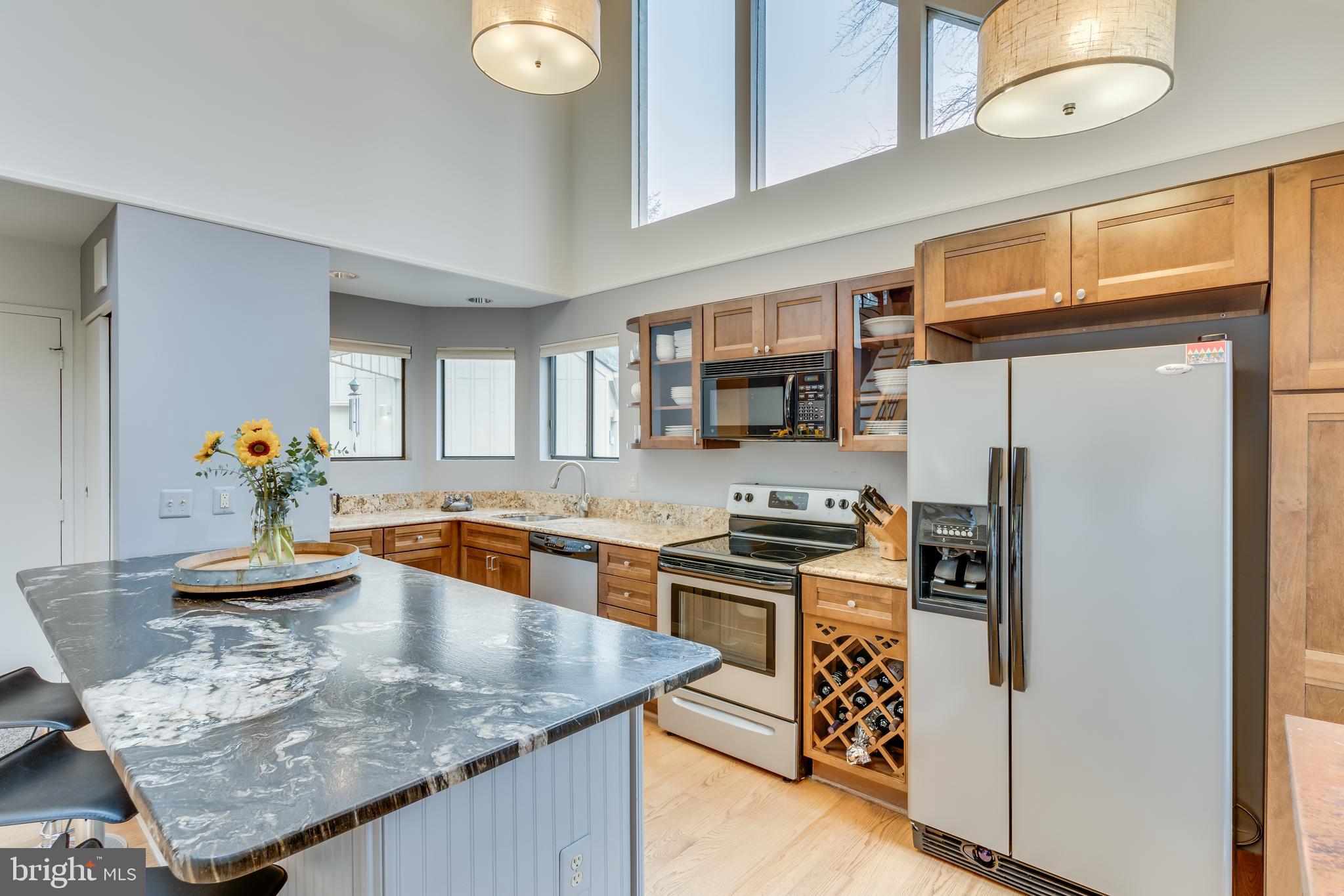 11900 Moss Point Lane Reston, VA 20194 - Photo 5 of 33 a kitchen with stainless steel appliances granite countertop a sink refrigerator stove and microwave