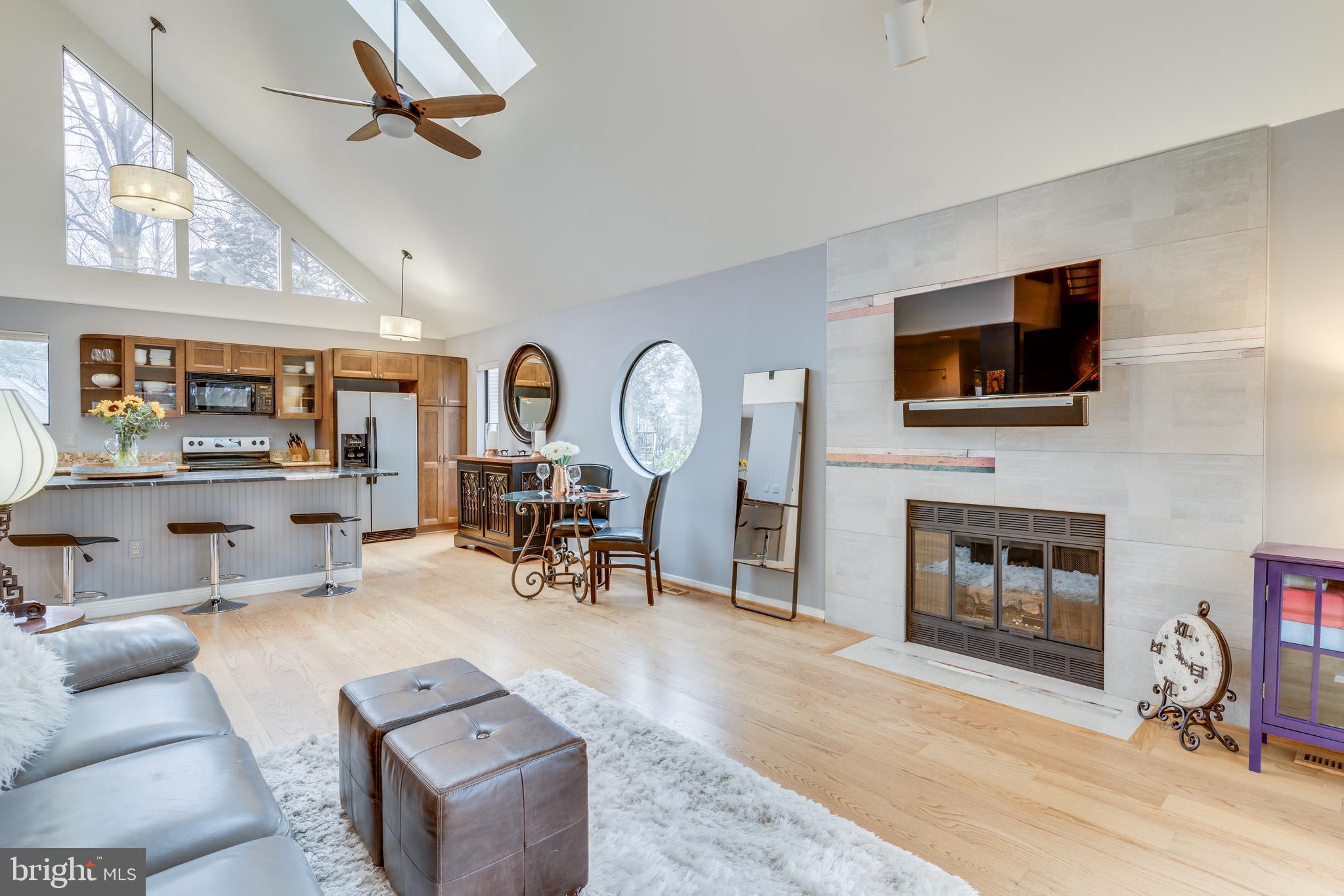 11900 Moss Point Lane Reston, VA 20194 - Photo 7 of 33 a living room with furniture a fireplace and a flat screen tv