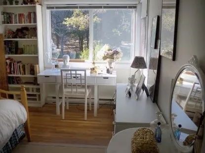 a living room with furniture a flat screen tv and a floor to ceiling window