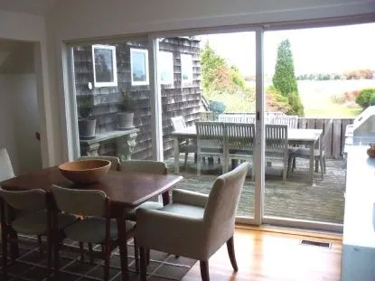 a dining room with furniture a chandelier and wooden floor