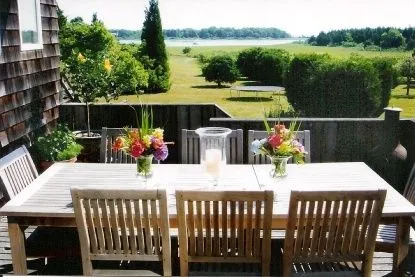 a view of a dining room with furniture and outdoor kitchen