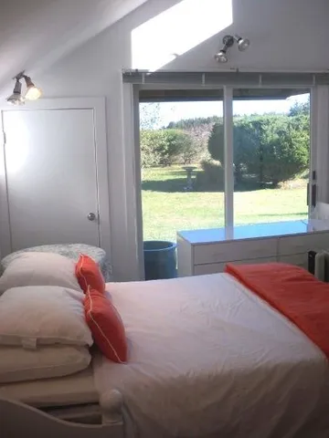 a bedroom with a bed and a large window