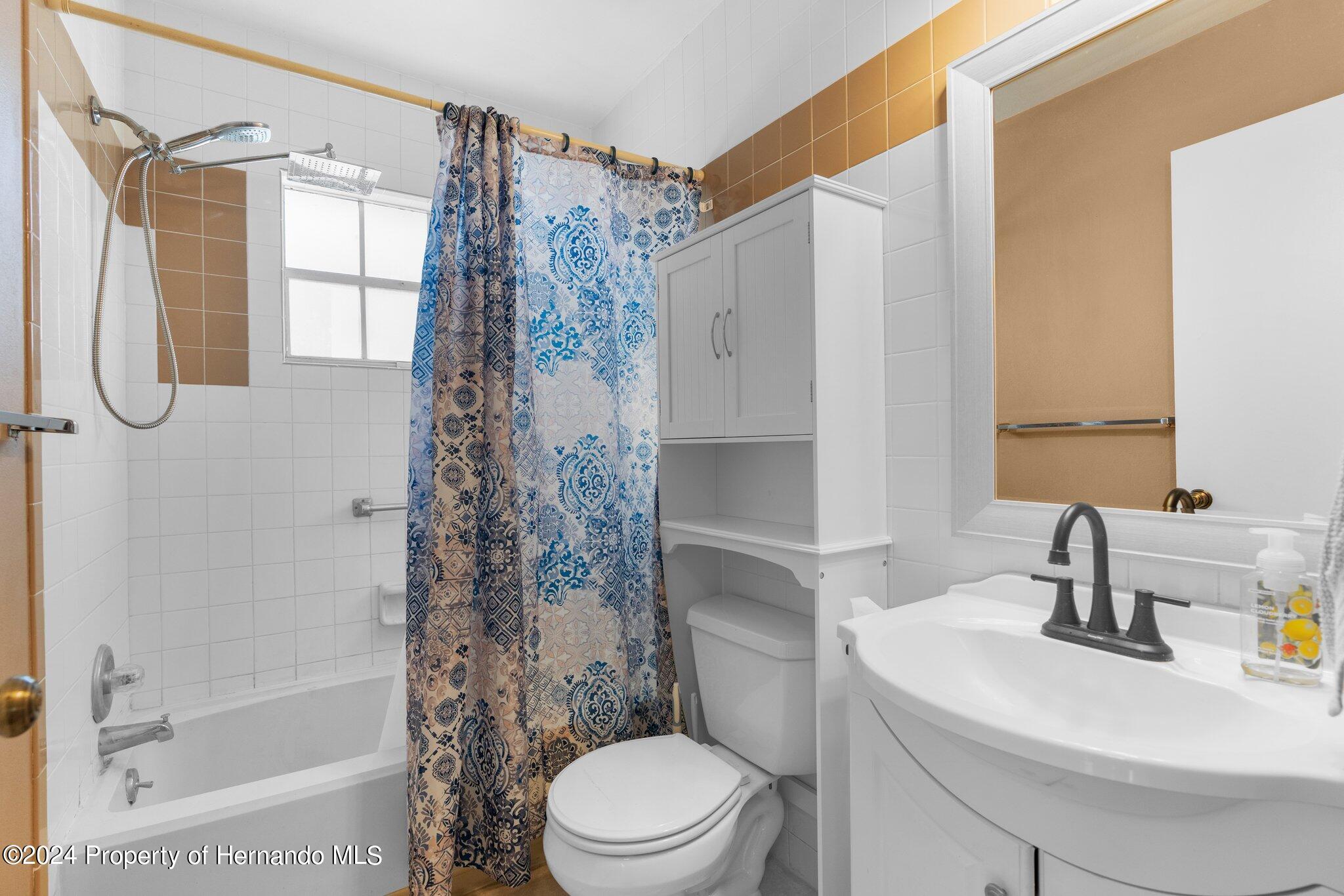 9124 Eldridge Road Spring Hill, FL 34608 - Photo 16 of 26 a bathroom with a sink toilet and shower