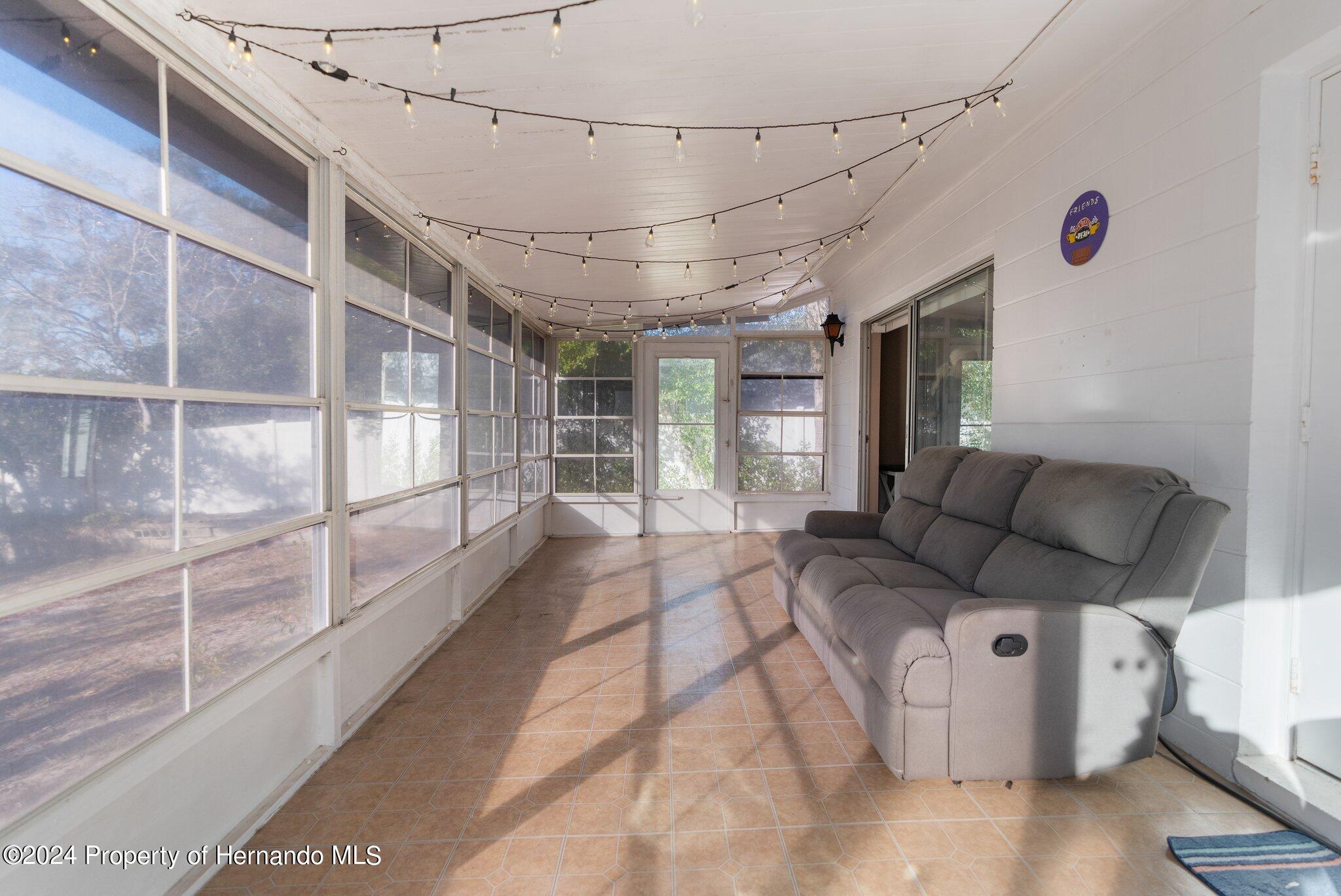9124 Eldridge Road Spring Hill, FL 34608 - Photo 20 of 26 a view of a livingroom with furniture and window