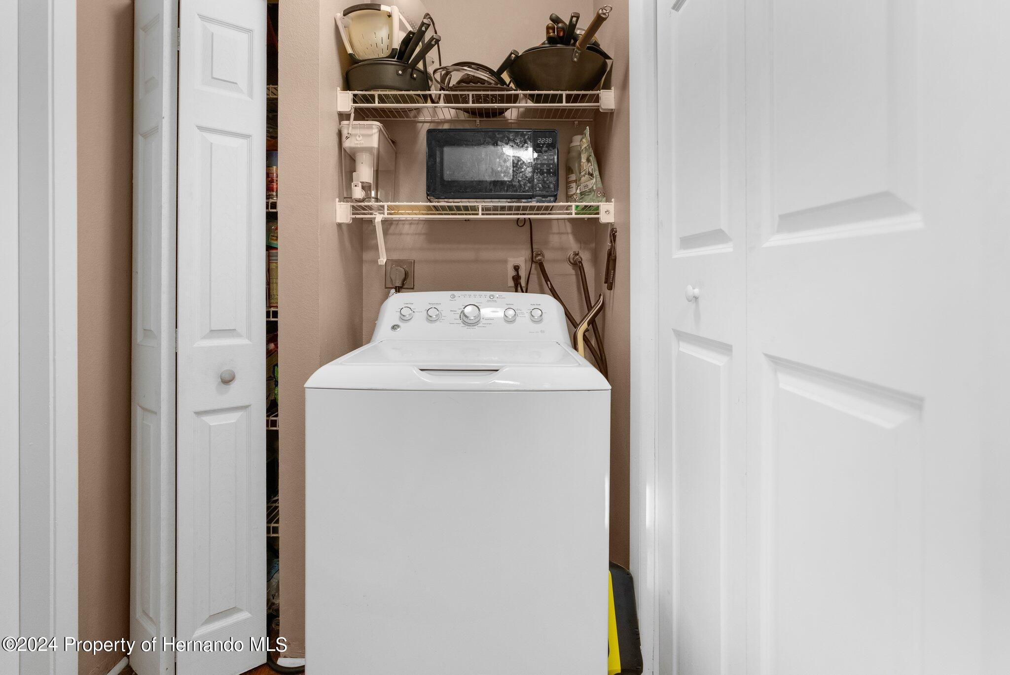 9124 Eldridge Road Spring Hill, FL 34608 - Photo 21 of 26 a utility room with dryer and washer