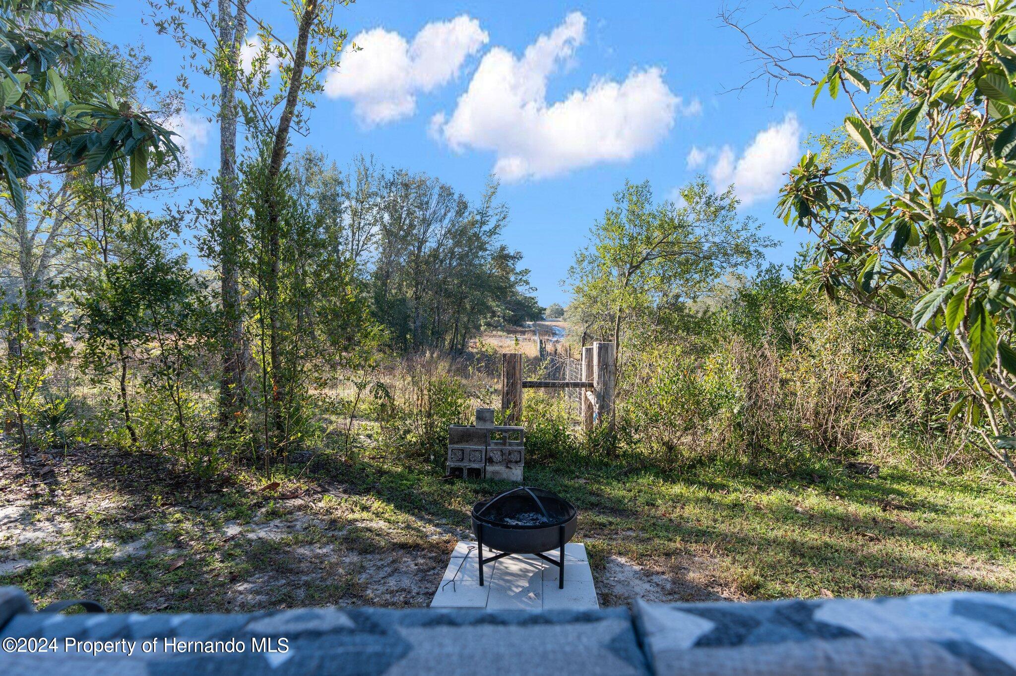 9124 Eldridge Road Spring Hill, FL 34608 - Photo 23 of 26 a view of a yard in the middle of a yard