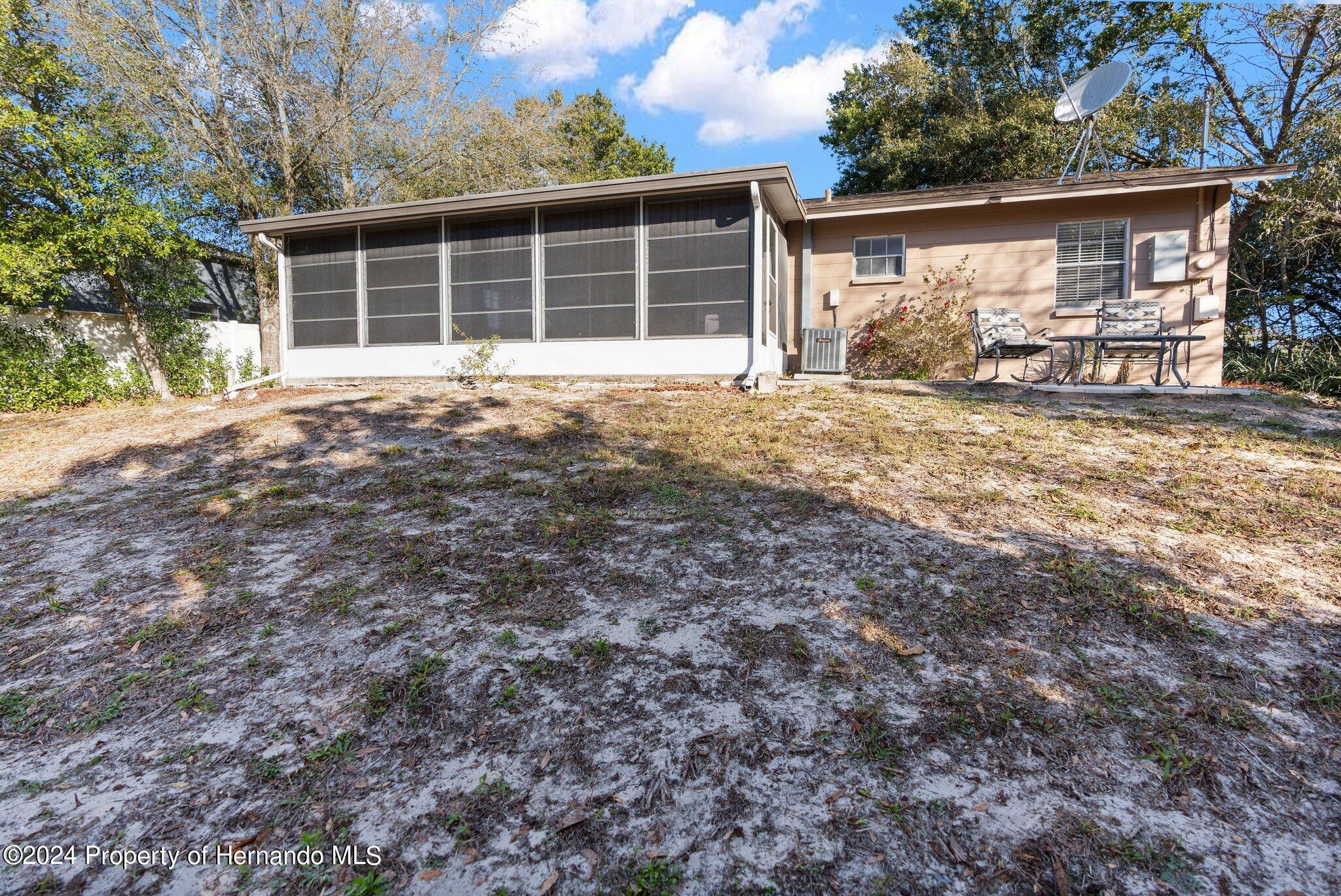 9124 Eldridge Road Spring Hill, FL 34608 - Photo 24 of 26 a front view of a house with garden