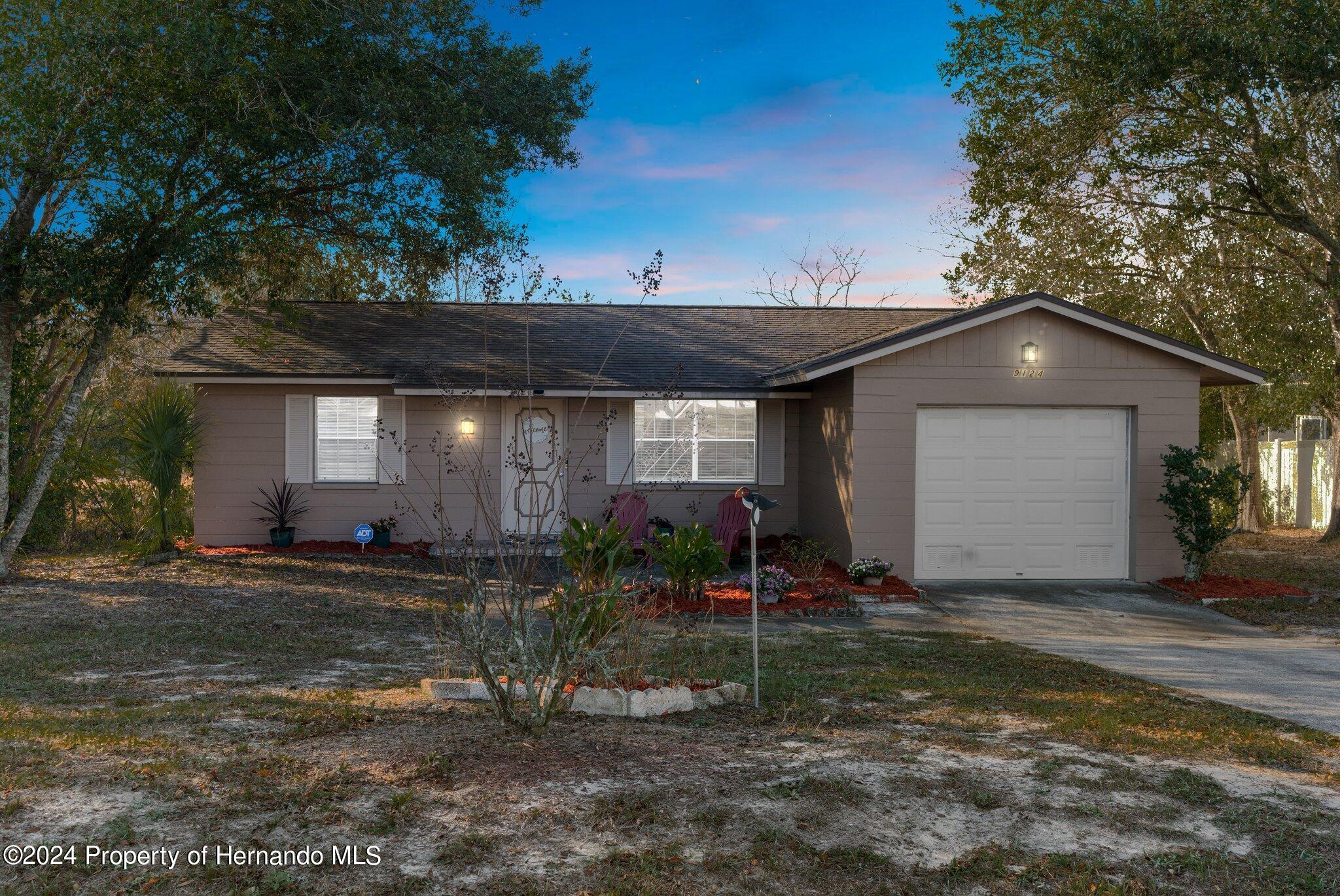 9124 Eldridge Road Spring Hill, FL 34608 - Photo 26 of 26 a front view of a house with garden