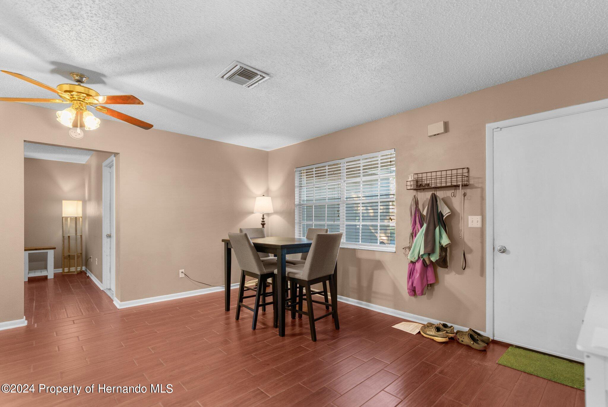 9124 Eldridge Road Spring Hill, FL 34608 - Photo 6 of 26 a view of a dining room with furniture and a window